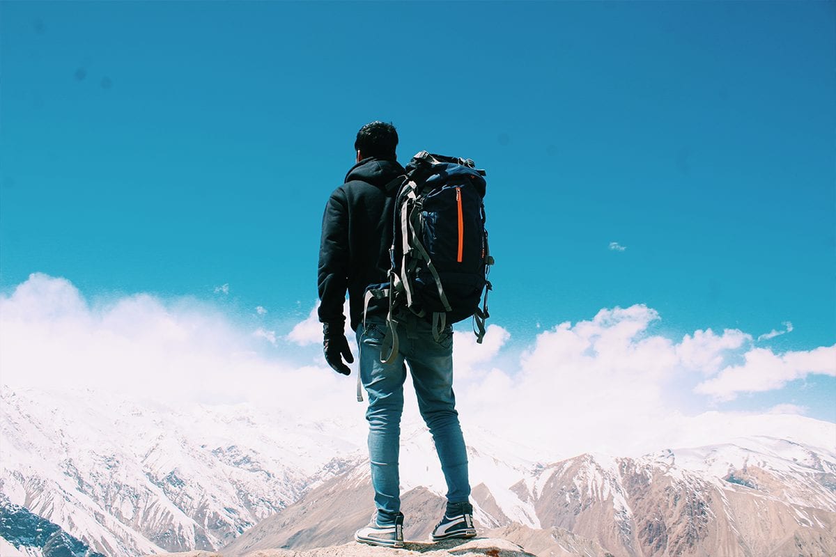 Man backpacking on the mountains - how much does branding cost