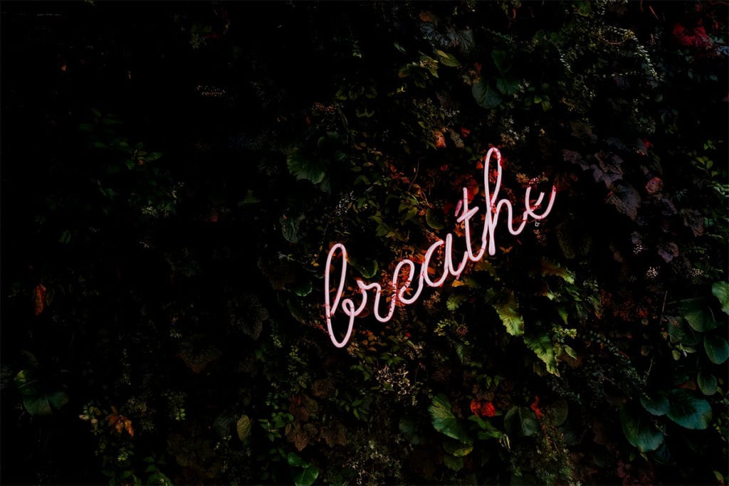 neon sign of the word Breathe