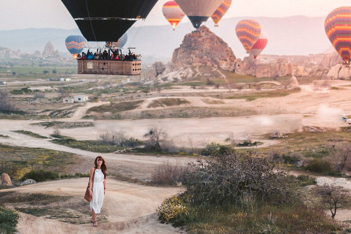 Woman near hot air balloons in Turkey - how much does branding cost