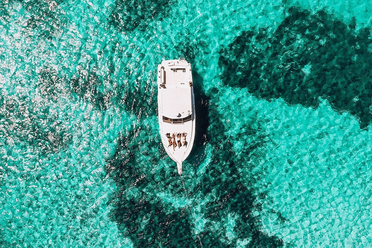 Aerial view of yacht on a light blue ocean- how much does branding cost